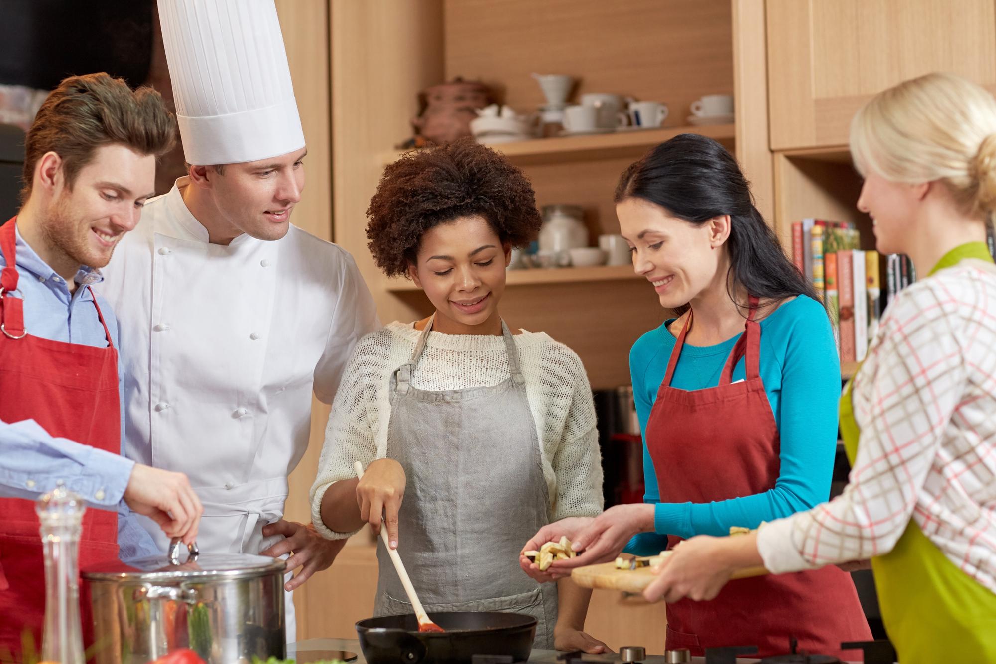 Small group cooking around a table with instructor
